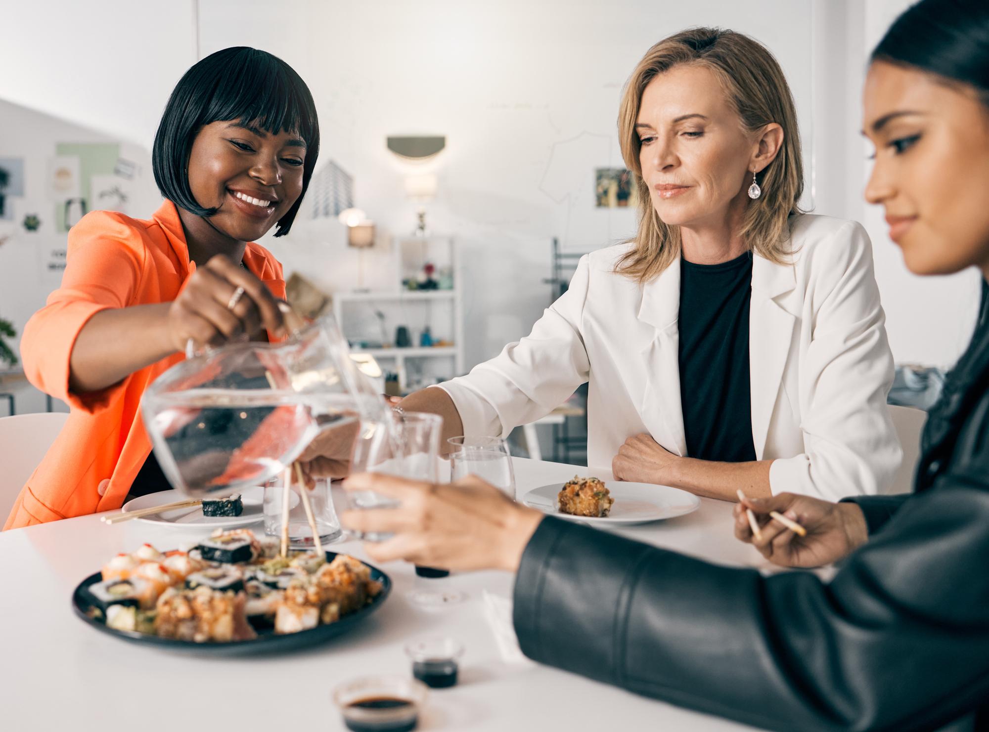 Participants sharing dishes at a modern table